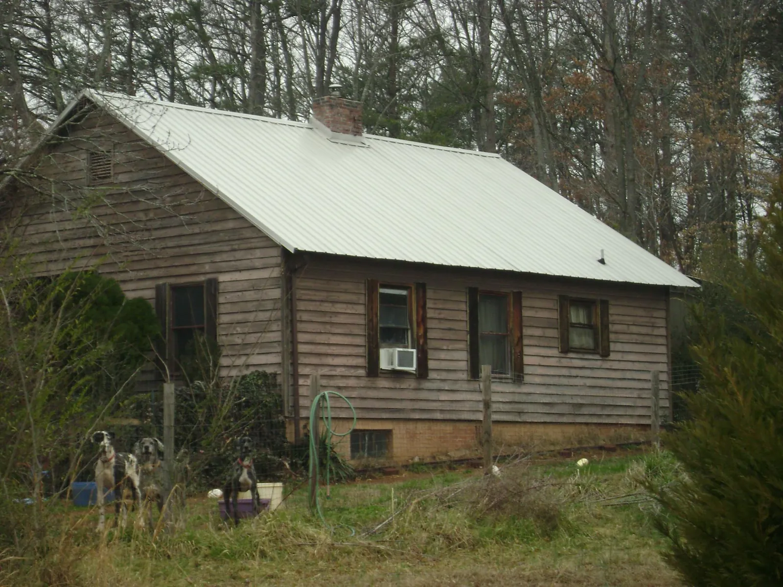 White metal roof on an old wood sided farmhouse, from a Metal Roof Installation job in Sprague